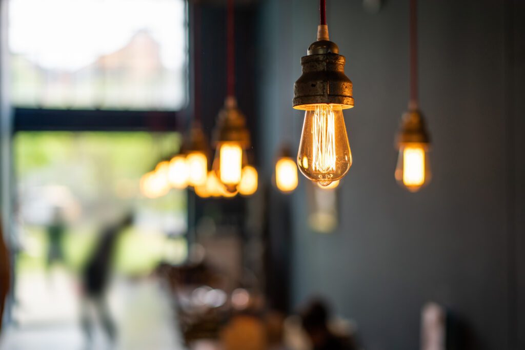 Copper coloured lights hanging from the ceiling