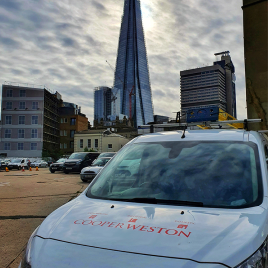 Cooper Weston van parked below The Shard building in London